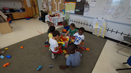 Kindergarten students playing in a classroom.