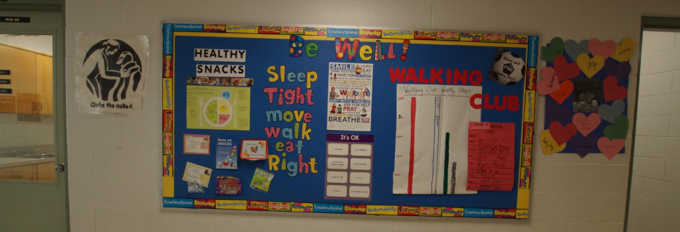 "Be well" bulletin board with several posters on best practices in mental and physical health.