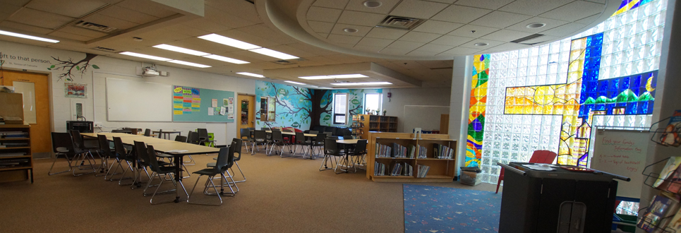 Learning Commons area of the school with books and tables